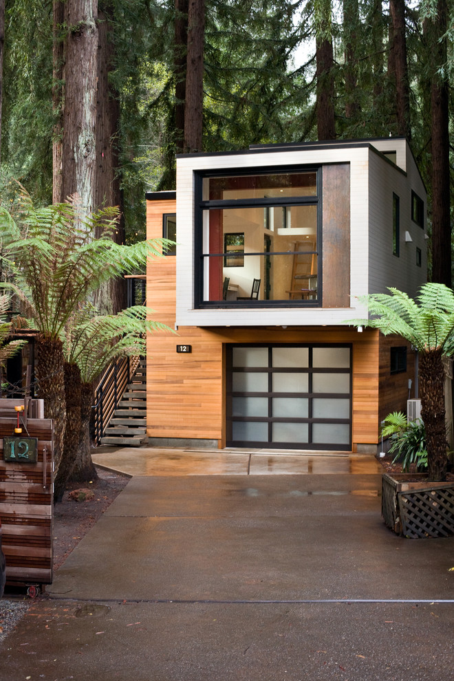 This is an example of a small modern two-storey exterior in San Francisco with wood siding and a flat roof.