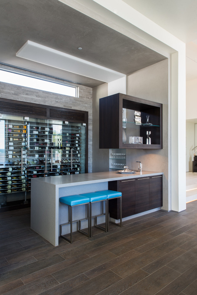 Contemporary seated home bar in San Luis Obispo with brown cabinets, brown floor and grey benchtop.