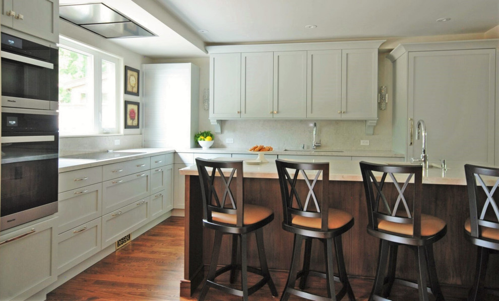 Open concept kitchen - mid-sized transitional l-shaped medium tone wood floor open concept kitchen idea with an undermount sink, recessed-panel cabinets, blue cabinets, quartz countertops, white backsplash, quartz backsplash, an island and white countertops