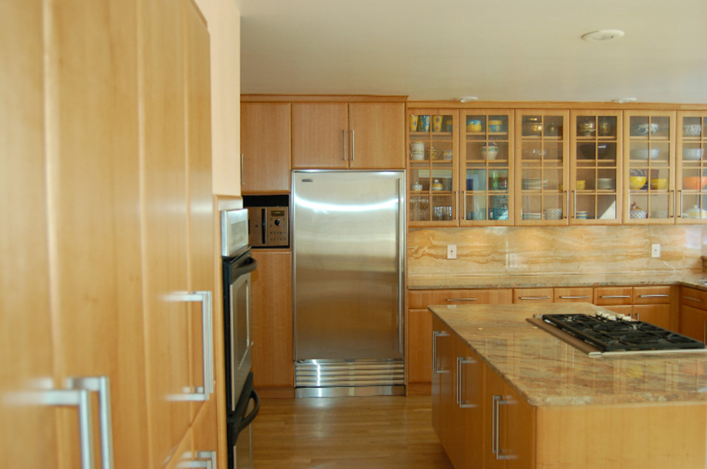 Kitchen - light wood floor kitchen idea with flat-panel cabinets, light wood cabinets, stainless steel appliances and an island