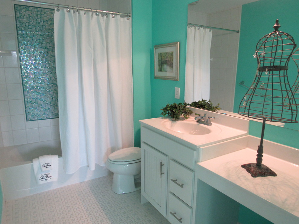 This is an example of a small modern kids bathroom in Philadelphia with beaded inset cabinets, white cabinets, a drop-in tub, a one-piece toilet, white tile, porcelain tile, blue walls, porcelain floors, an integrated sink, solid surface benchtops and a corner shower.