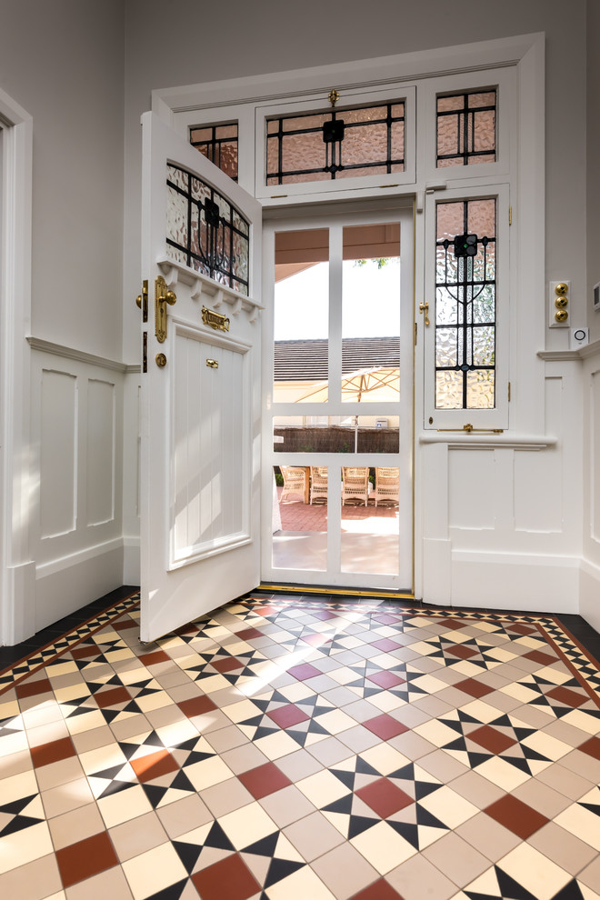 Photo of a mid-sized traditional hallway in Adelaide with grey walls and ceramic floors.