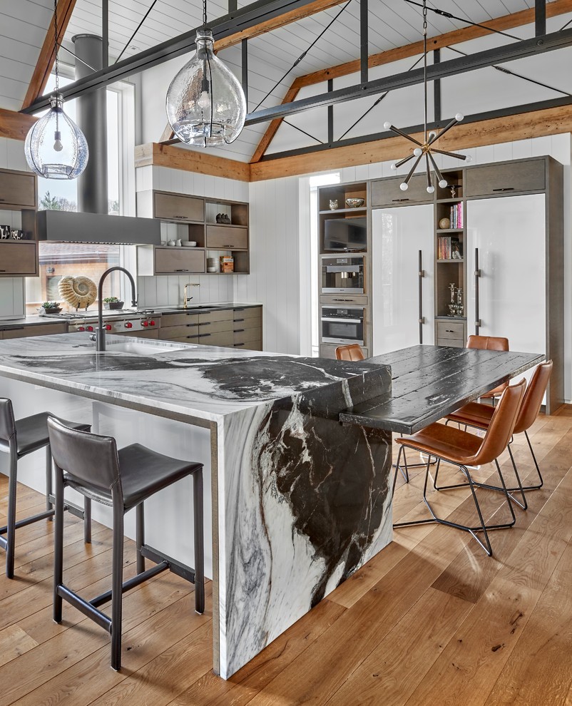 Inspiration for a contemporary kitchen in Chicago with granite benchtops, medium hardwood floors, flat-panel cabinets, white splashback, timber splashback, stainless steel appliances, with island and brown floor.