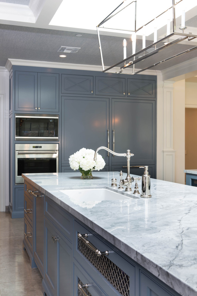 Design ideas for an expansive l-shaped eat-in kitchen in Los Angeles with an undermount sink, shaker cabinets, blue cabinets, quartzite benchtops, white splashback, ceramic splashback, panelled appliances, limestone floors, multiple islands, grey floor and white benchtop.