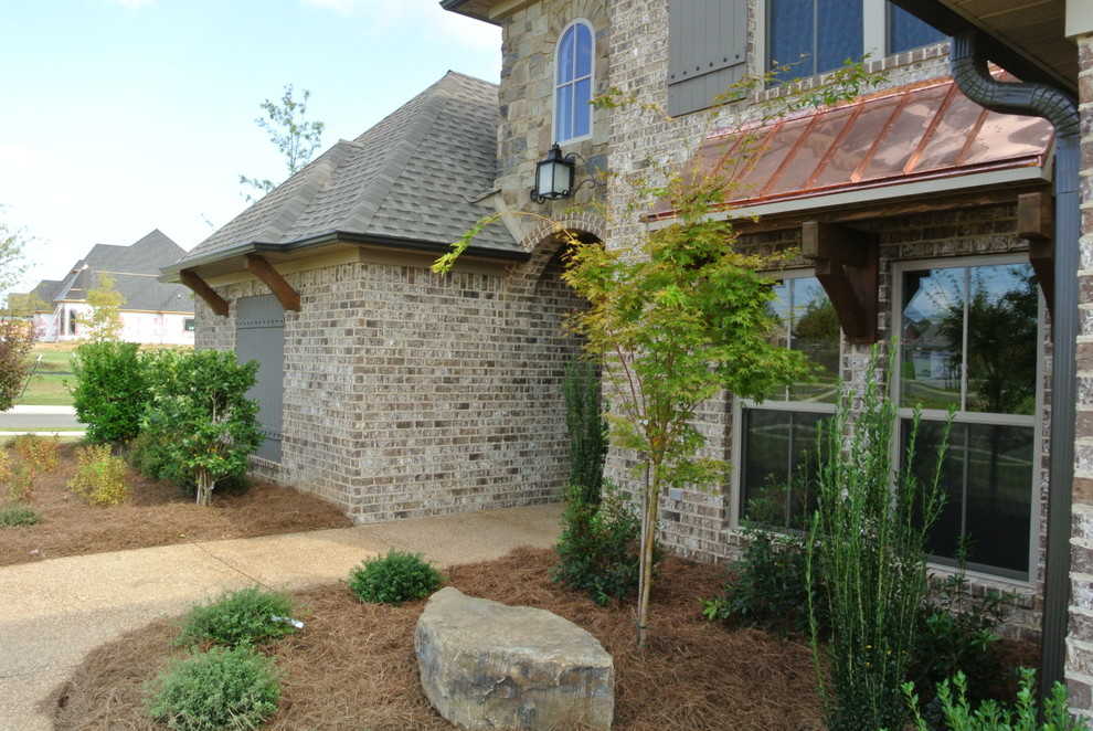 Mountain style two-story brick brown home design photo