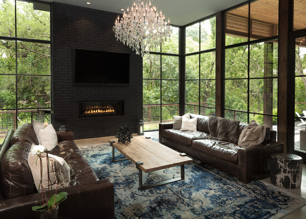 Photo of a large contemporary open concept family room in Dallas with grey walls, concrete floors, a ribbon fireplace, a brick fireplace surround and a wall-mounted tv.