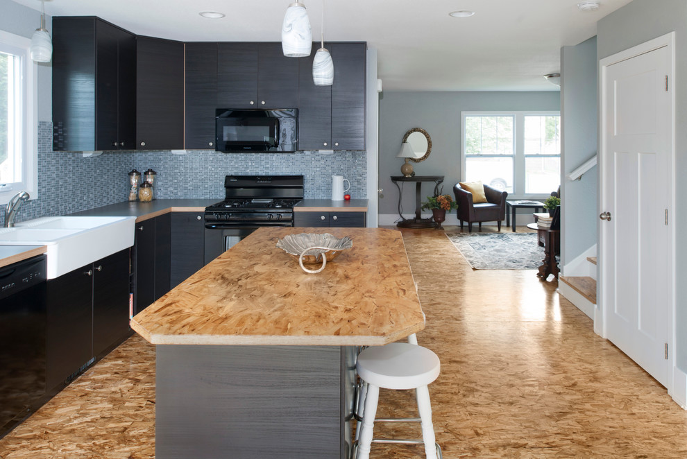Example of a small transitional l-shaped eat-in kitchen design in Minneapolis with a farmhouse sink, flat-panel cabinets, dark wood cabinets, laminate countertops, mosaic tile backsplash, black appliances and an island