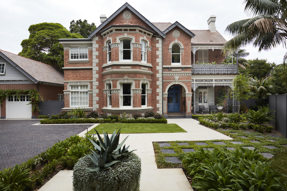 Inspiration for a large traditional two-storey brick grey house exterior in Sydney with a gable roof and a tile roof.