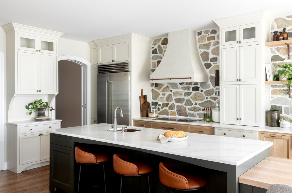 Transitional kitchen photo with an island