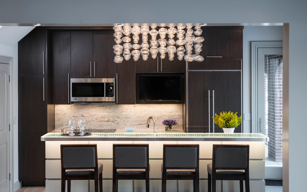 Design ideas for a large contemporary galley eat-in kitchen in Detroit with an undermount sink, flat-panel cabinets, dark wood cabinets, glass benchtops, brown splashback, ceramic floors, with island and panelled appliances.