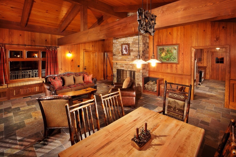 Inspiration for a country dining room in Other with a standard fireplace and a stone fireplace surround.