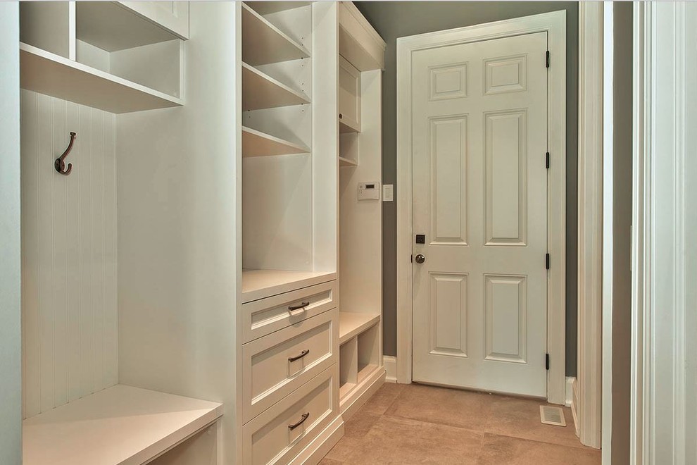 Photo of a mid-sized transitional mudroom in Toronto with grey walls, travertine floors, a single front door and a white front door.