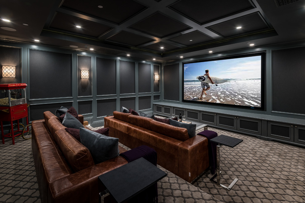 Traditional home theatre in Los Angeles with black walls, carpet and grey floor.