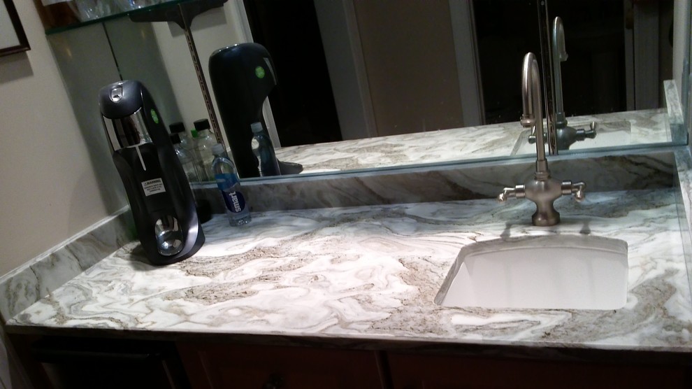 This is an example of a small traditional wet bar in Atlanta with an undermount sink and quartzite benchtops.