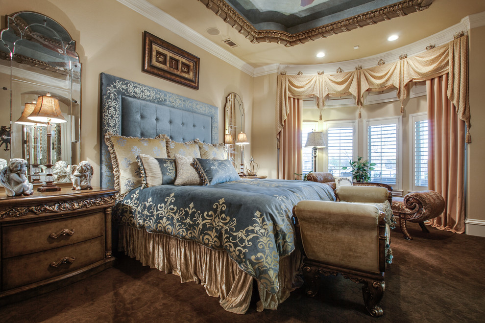 This is an example of a large traditional master bedroom in Dallas with beige walls and carpet.