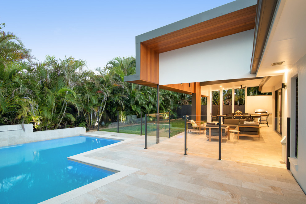 Photo of a mid-sized contemporary backyard patio in Brisbane with a water feature, tile and a roof extension.