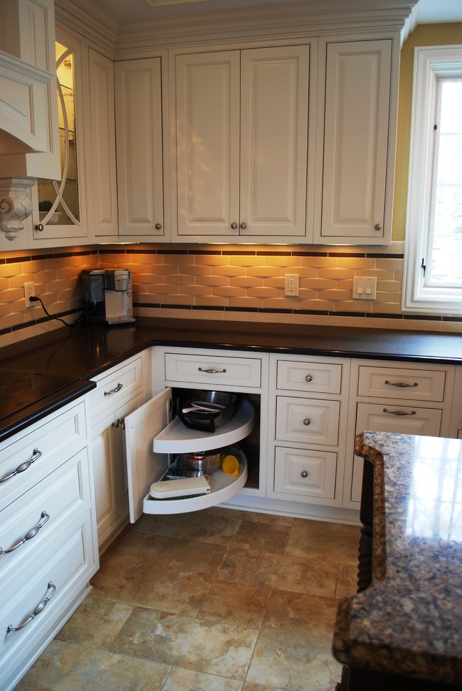 This is an example of a large traditional u-shaped separate kitchen in Cleveland with a farmhouse sink, beaded inset cabinets, white cabinets, quartz benchtops, porcelain splashback, stainless steel appliances, porcelain floors and with island.