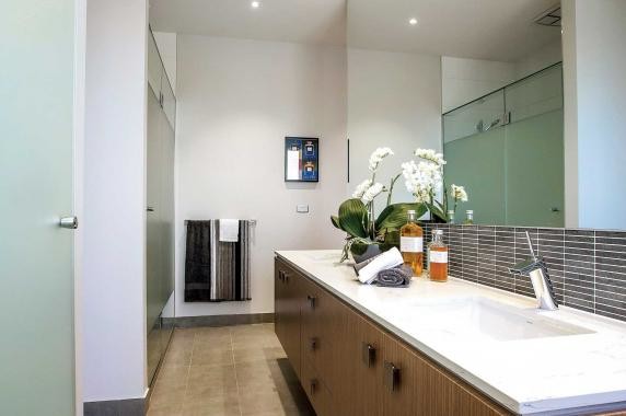 Photo of a large contemporary master bathroom in Melbourne with an undermount sink, furniture-like cabinets, medium wood cabinets, engineered quartz benchtops, brown tile, white walls, porcelain floors, a double shower, mosaic tile, a wall-mount toilet, grey floor and a hinged shower door.