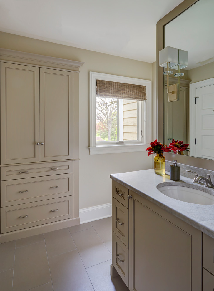 Design ideas for a mid-sized traditional 3/4 bathroom in Other with raised-panel cabinets, beige cabinets, a corner tub, an open shower, a one-piece toilet, gray tile, white tile, marble, beige walls, dark hardwood floors, a drop-in sink, marble benchtops and an open shower.