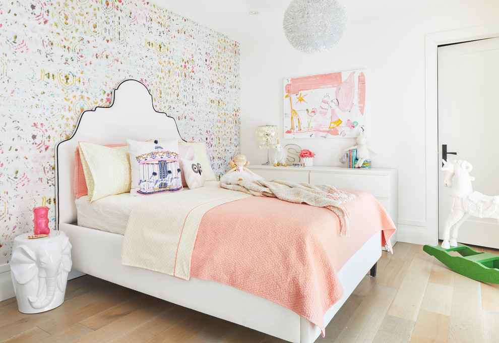 Transitional kids' bedroom in Toronto with multi-coloured walls, light hardwood floors and beige floor for girls.