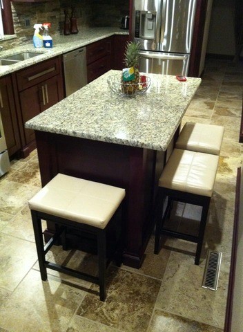 Inspiration for a large galley light wood floor enclosed kitchen remodel in Cedar Rapids with a drop-in sink, flat-panel cabinets, black cabinets, metallic backsplash and an island