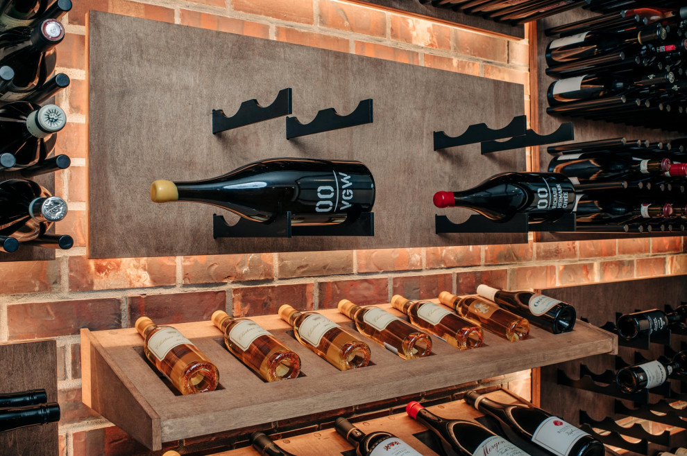 Inspiration for a small contemporary wine cellar in Portland with dark hardwood floors, display racks and brown floor.