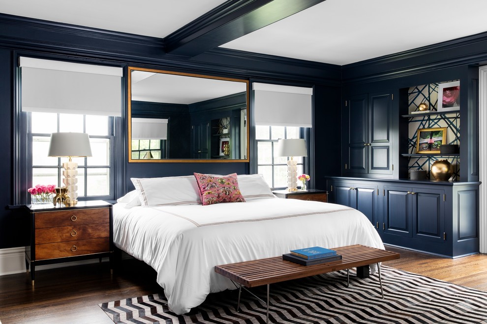 Inspiration for a large transitional master bedroom in New York with blue walls, dark hardwood floors, no fireplace and brown floor.