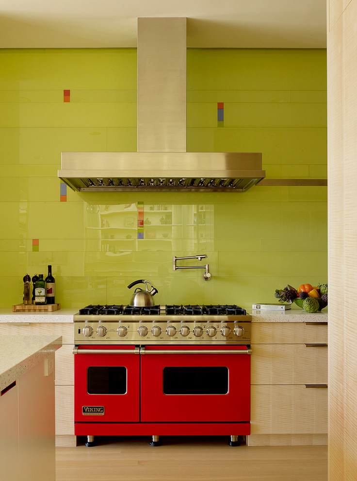 This is an example of a contemporary kitchen in San Francisco with flat-panel cabinets, light wood cabinets, green splashback, glass tile splashback and coloured appliances.