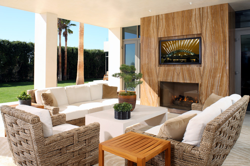 Inspiration for a contemporary backyard patio in Los Angeles with a fire feature and tile.