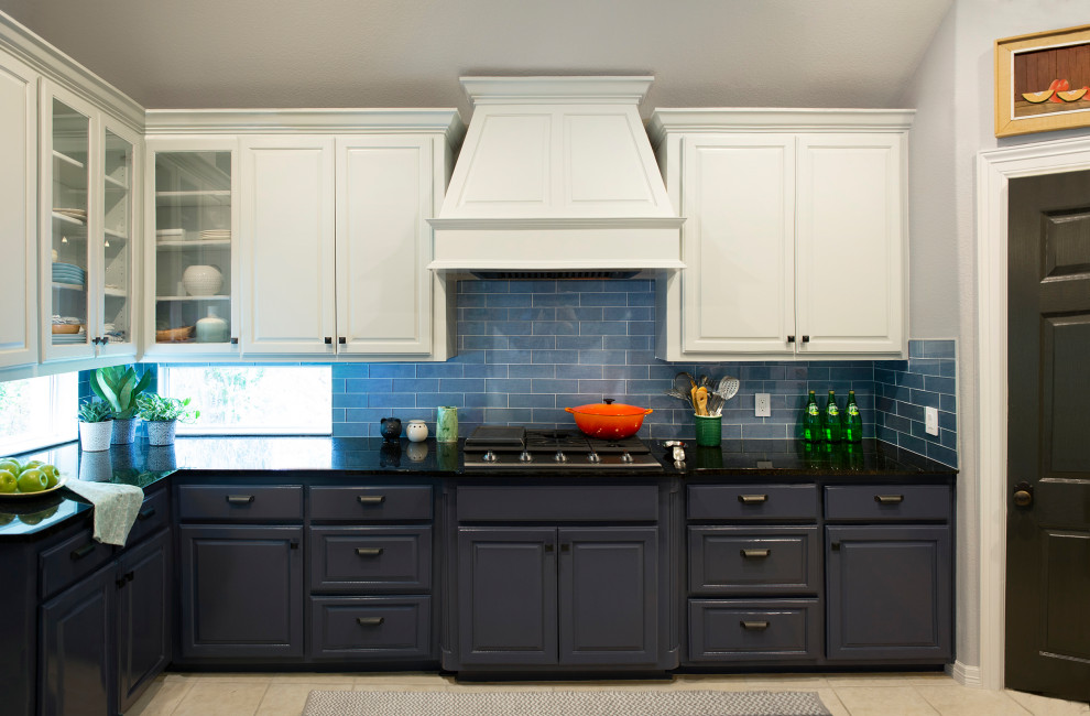Inspiration for a mid-sized eclectic separate kitchen in Austin with raised-panel cabinets, blue cabinets, granite benchtops, blue splashback, glass tile splashback, stainless steel appliances, with island and black benchtop.