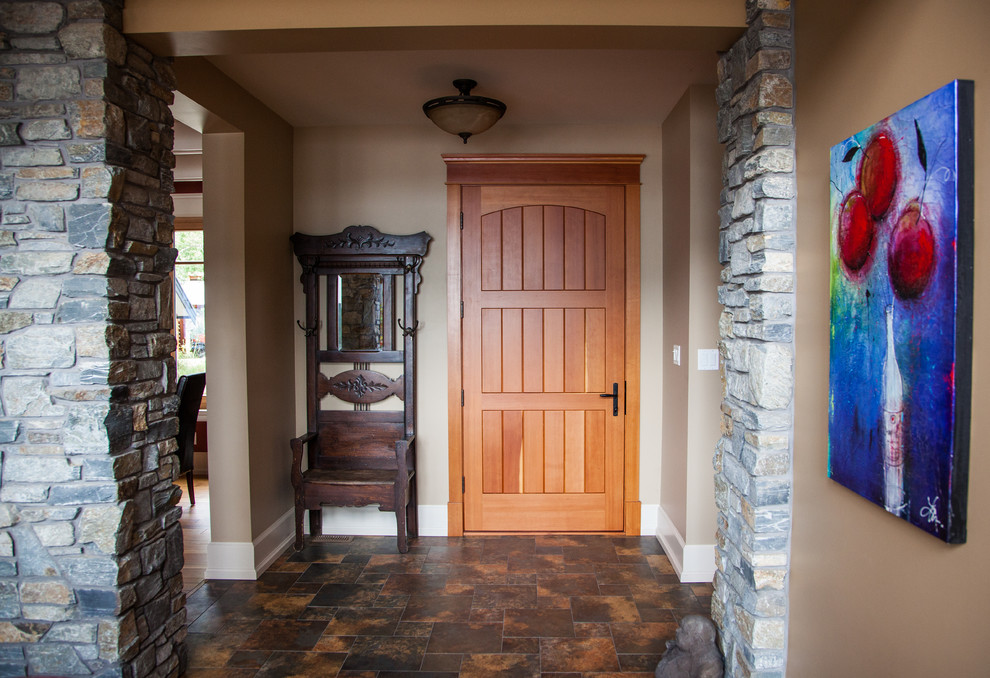 Inspiration for a mid-sized craftsman porcelain tile and brown floor front door remodel with brown walls and a medium wood front door
