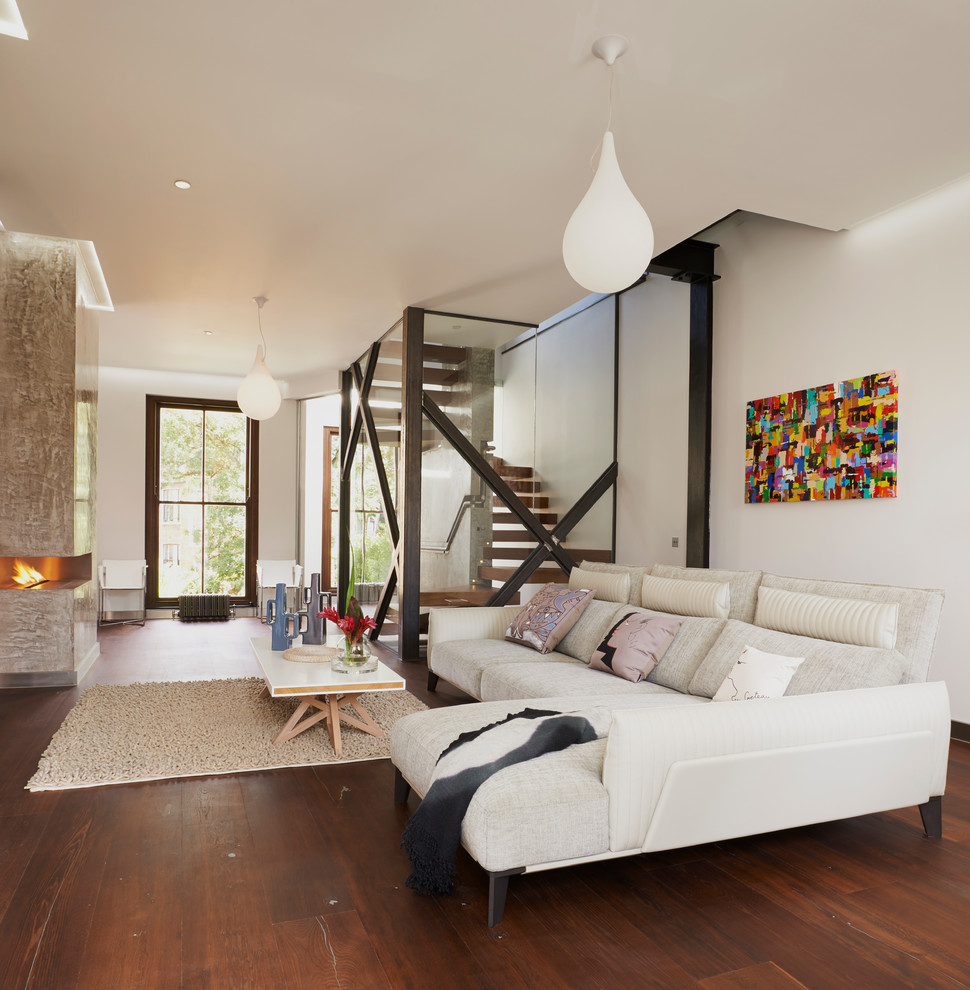 Contemporary living room in London with dark hardwood floors.