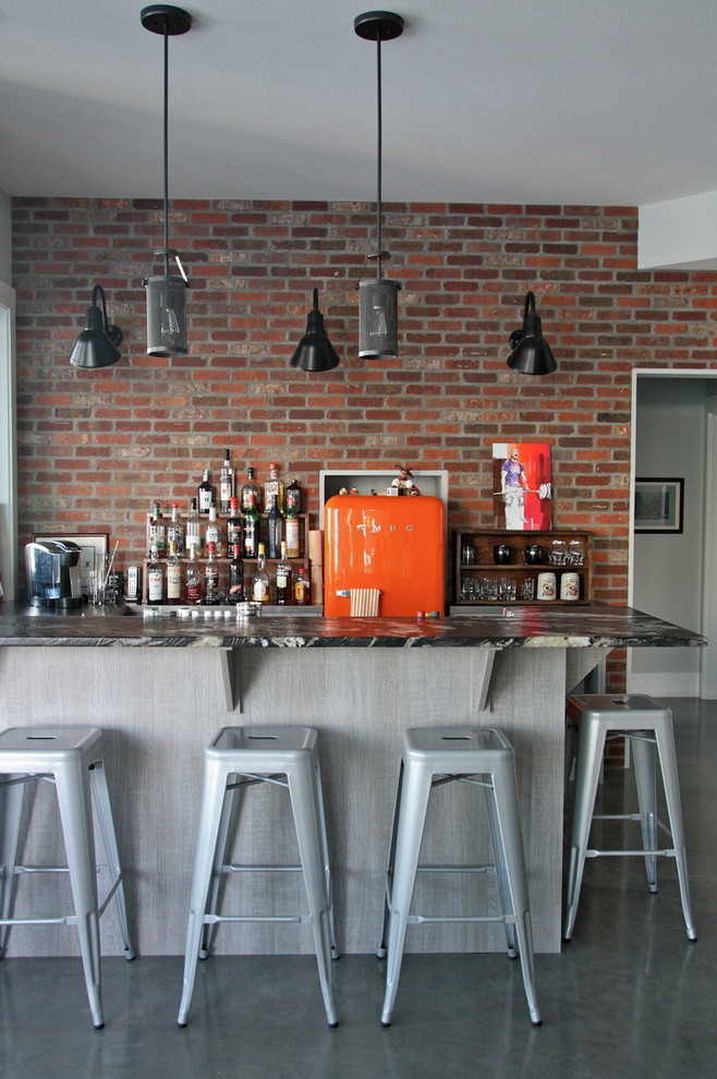 Seated home bar - industrial gray floor seated home bar idea in Vancouver with brick backsplash and gray countertops