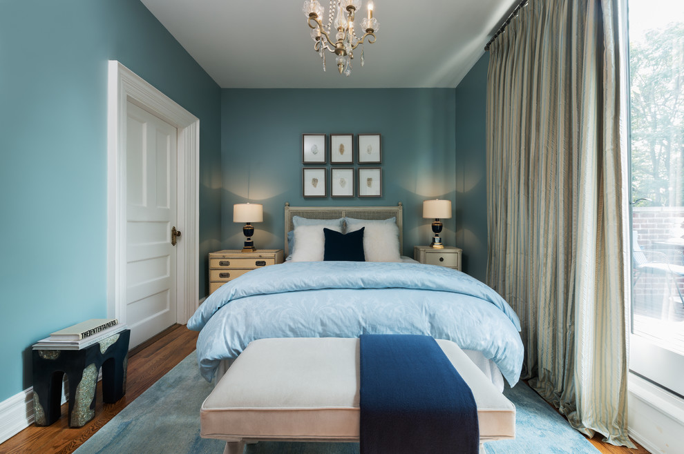 Design ideas for a small eclectic guest bedroom in Toronto with blue walls, no fireplace and medium hardwood floors.