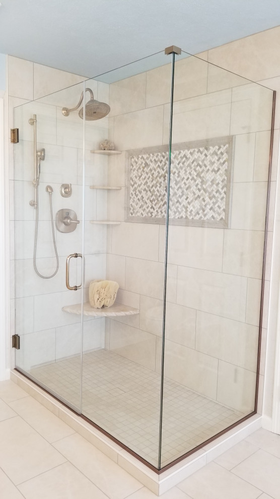 This is an example of a mid-sized traditional master bathroom in Other with recessed-panel cabinets, white cabinets, a freestanding tub, a corner shower, a two-piece toilet, beige tile, ceramic tile, white walls, ceramic floors, an integrated sink, engineered quartz benchtops, beige floor, a hinged shower door, multi-coloured benchtops, a double vanity and a built-in vanity.