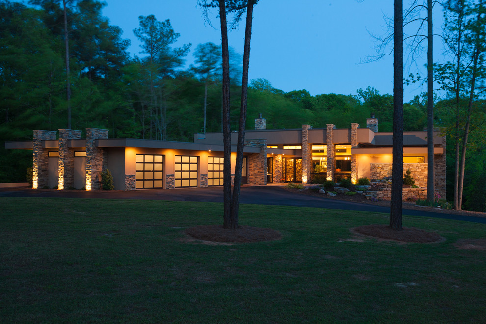 Large contemporary two-storey stucco beige exterior in Charlotte with a flat roof.