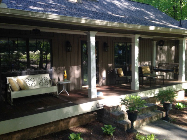 Inspiration for an expansive traditional front yard verandah in Atlanta with decking and a roof extension.