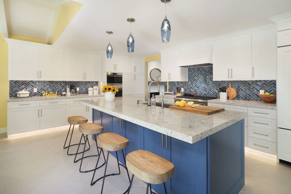 Example of a mid-sized minimalist l-shaped porcelain tile and gray floor eat-in kitchen design in Orange County with an undermount sink, shaker cabinets, white cabinets, quartz countertops, blue backsplash, glass tile backsplash, paneled appliances, an island and gray countertops