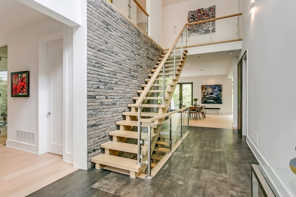 Example of a mid-sized transitional slate floor and gray floor entry hall design in Toronto with white walls
