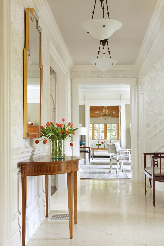Entry - A light filled entry utilizing antique pieces with updated upholstery. Photography by Peter Rymwid.