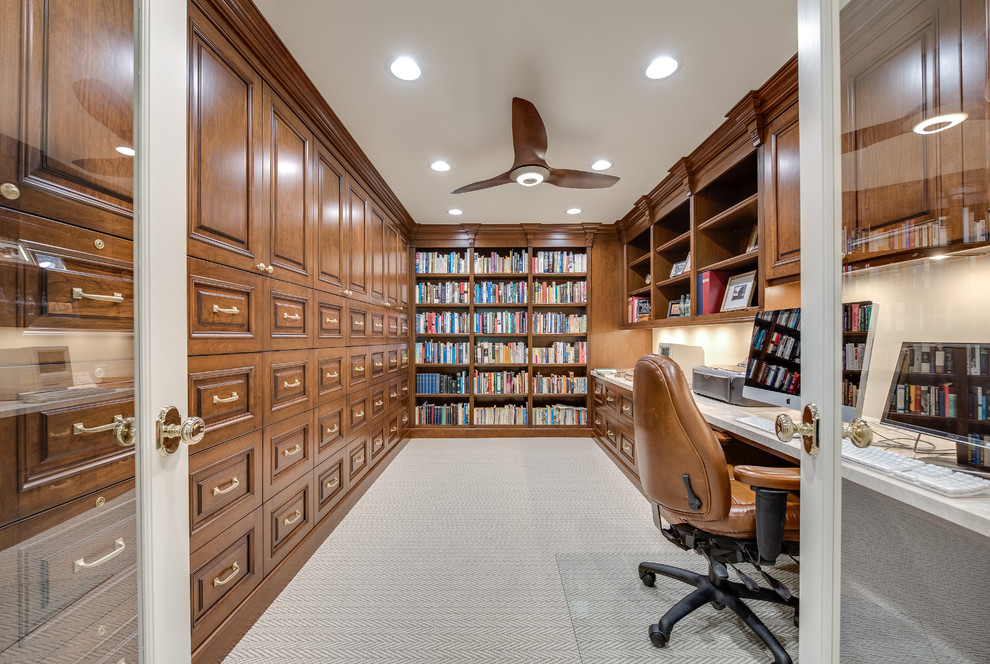 This is an example of a large traditional study room in Salt Lake City with beige walls, carpet and a built-in desk.