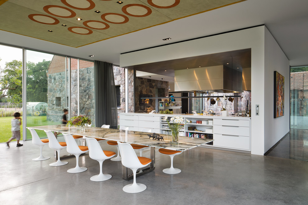 Inspiration for an expansive contemporary open plan dining in Berlin with concrete floors.