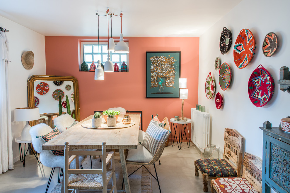 Design ideas for an eclectic dining room in Paris with red walls, concrete floors and grey floor.