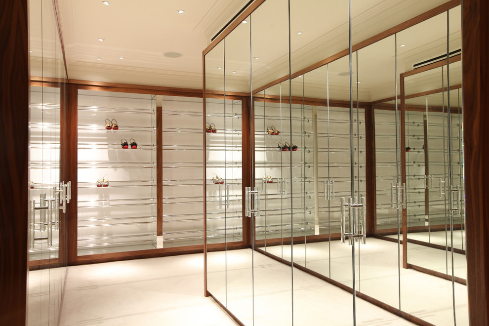 Large contemporary gender-neutral dressing room in London with flat-panel cabinets.