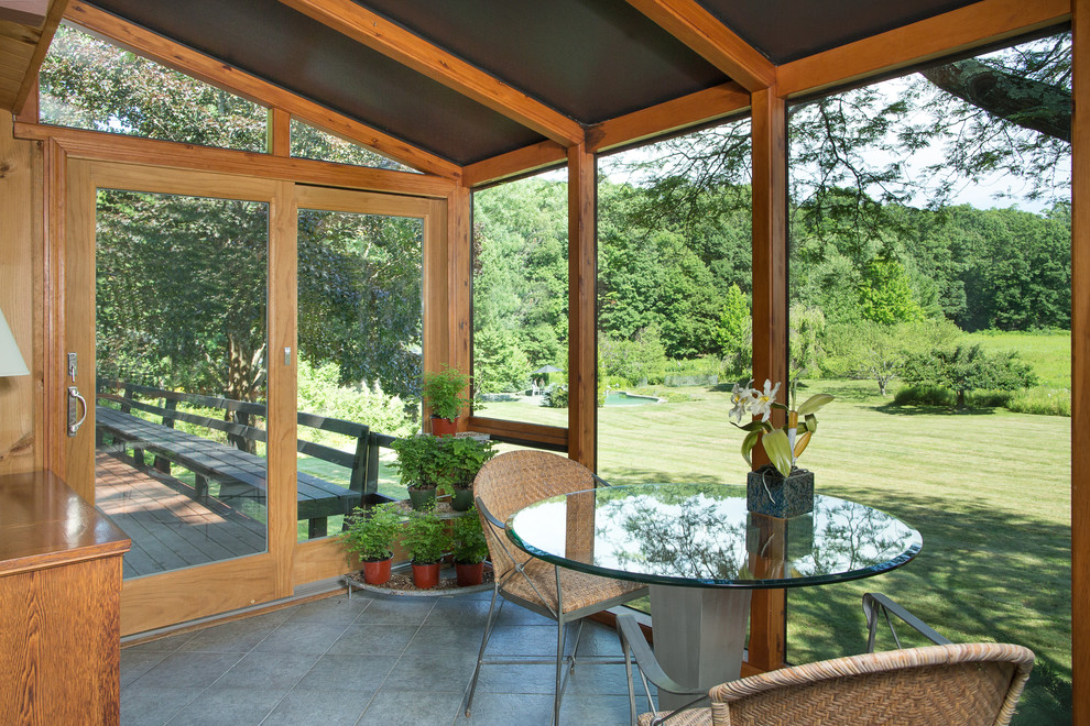 This is an example of a mid-sized midcentury sunroom in New York with ceramic floors and a standard ceiling.