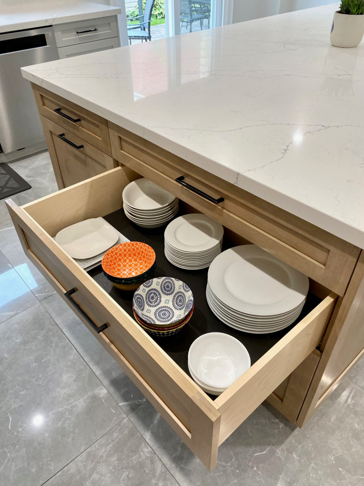 Example of a mid-sized transitional l-shaped porcelain tile open concept kitchen design in Toronto with an undermount sink, shaker cabinets, gray cabinets, quartz countertops, white backsplash, quartz backsplash, stainless steel appliances, an island and white countertops