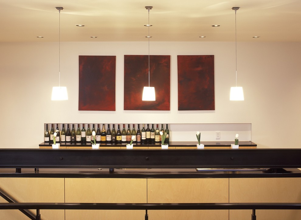 This is an example of a contemporary galley kitchen in Seattle with flat-panel cabinets and light wood cabinets.