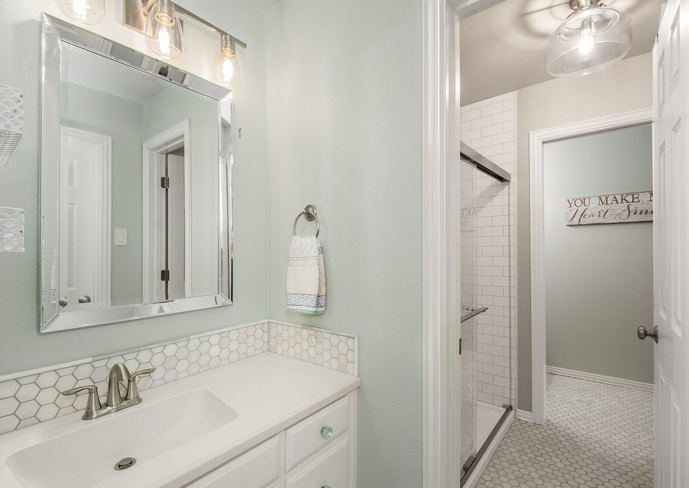 Mid-sized transitional kids bathroom in Dallas with flat-panel cabinets, white cabinets, a curbless shower, a two-piece toilet, white tile, ceramic tile, grey walls, marble floors, an integrated sink, marble benchtops, grey floor, a sliding shower screen and white benchtops.