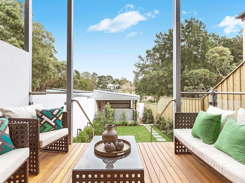 Inspiration for a small modern backyard patio in Sydney with decking and a roof extension.