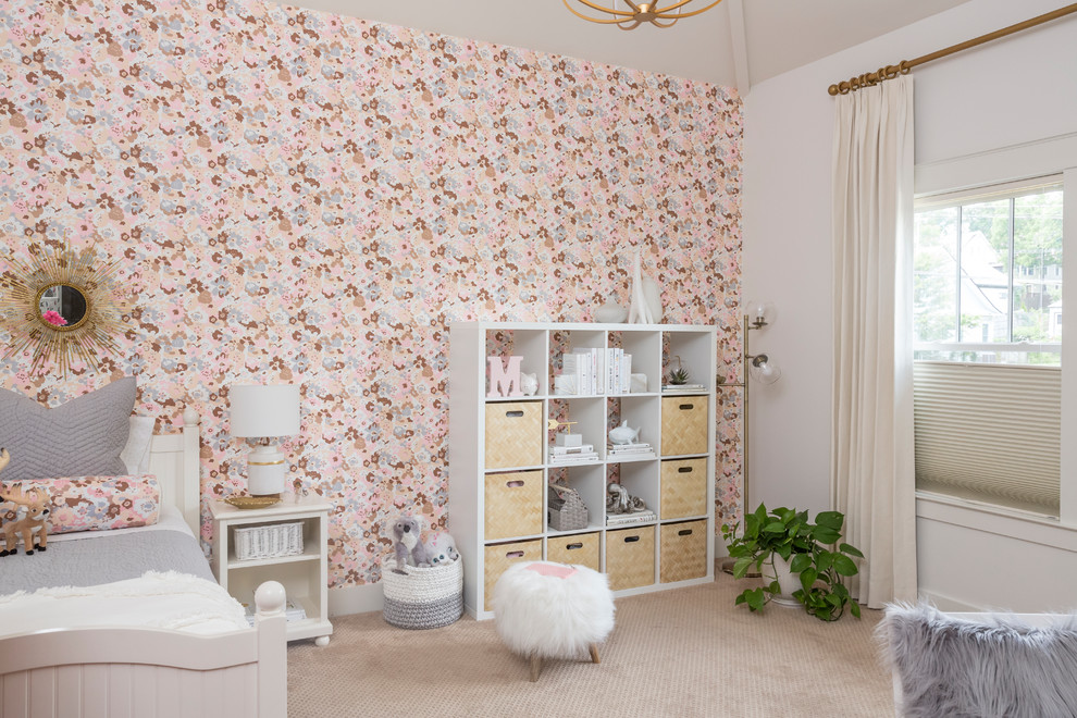 This is an example of a mid-sized transitional kids' bedroom for kids 4-10 years old and girls in Nashville with pink walls, carpet and beige floor.